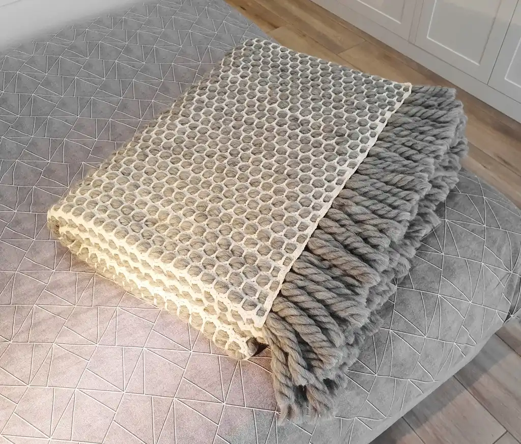 handmade crochet blanket made from chunky merino wool in natural color.