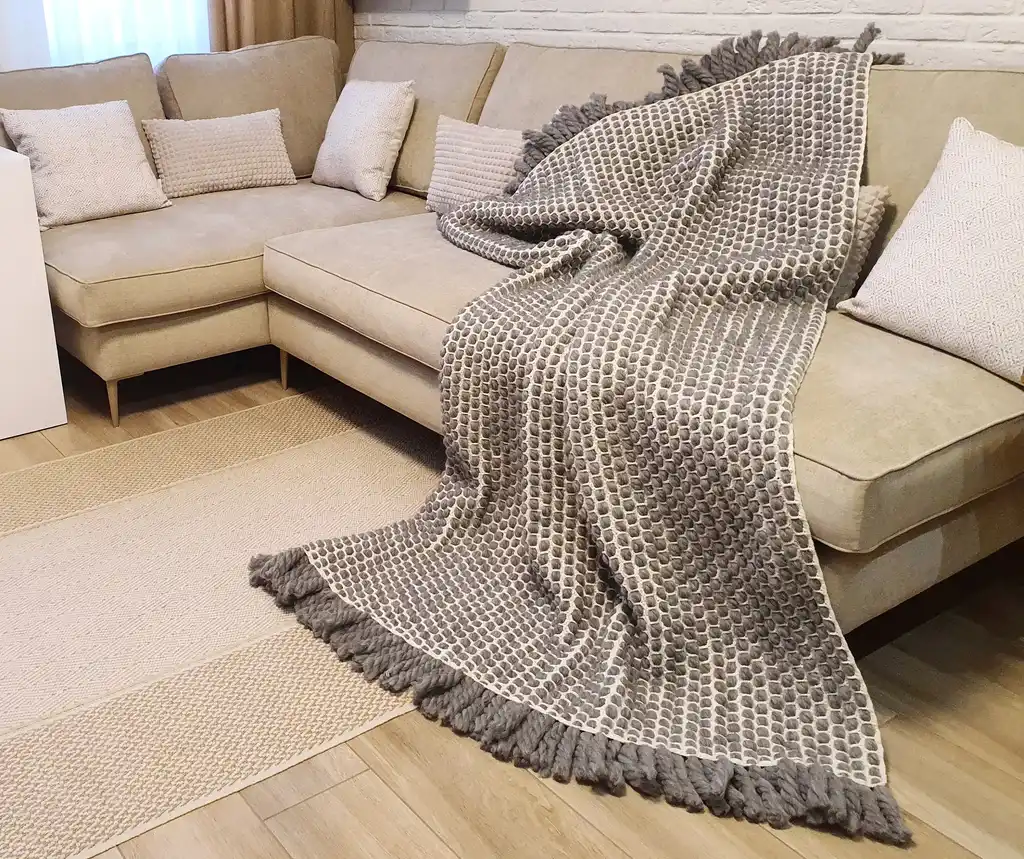 handmade crochet blanket made from chunky merino wool in natural color.