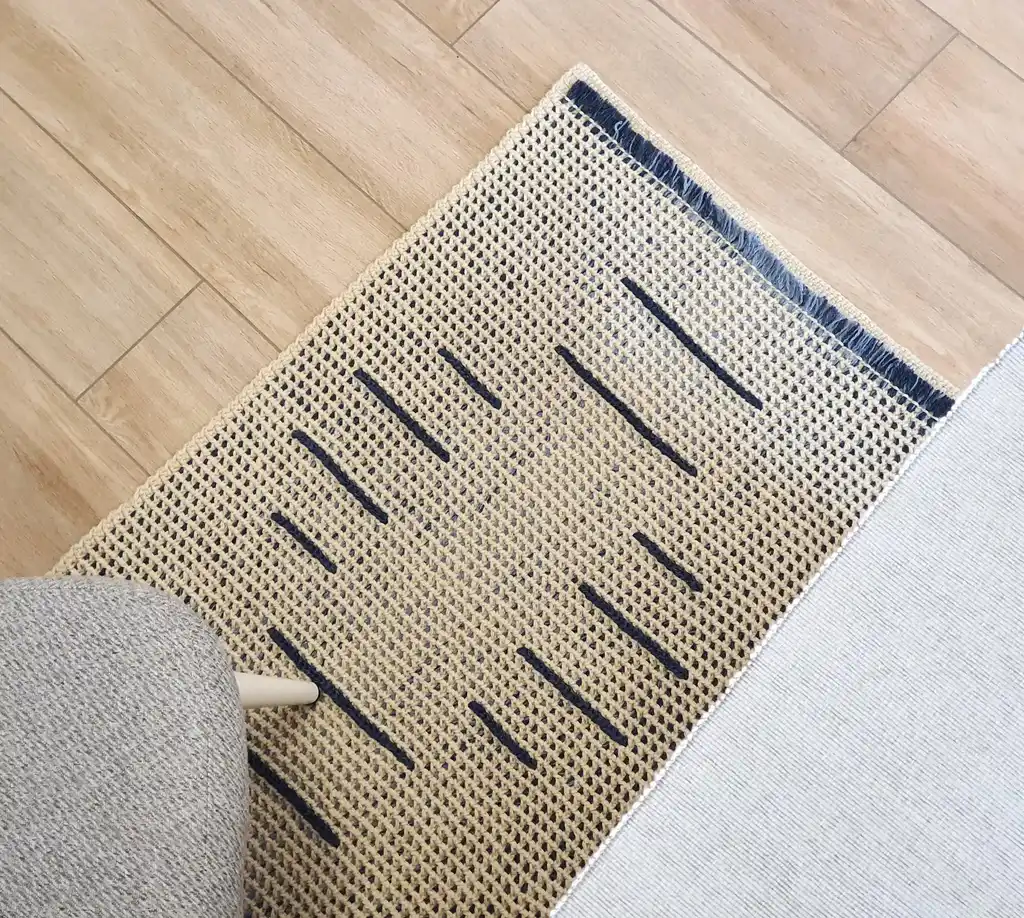 handmade crochet wool rug with intricate pattern, machine washable home decor.