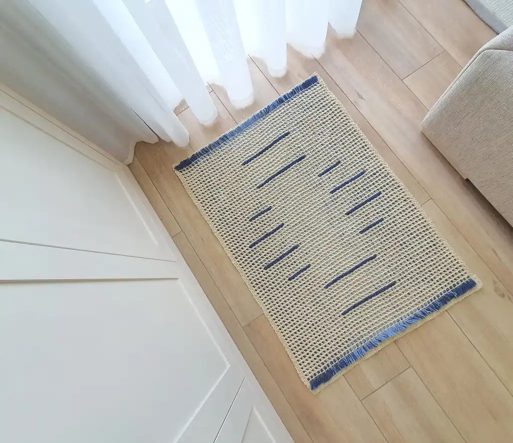 handmade crochet wool rug with intricate pattern, machine washable home decor.