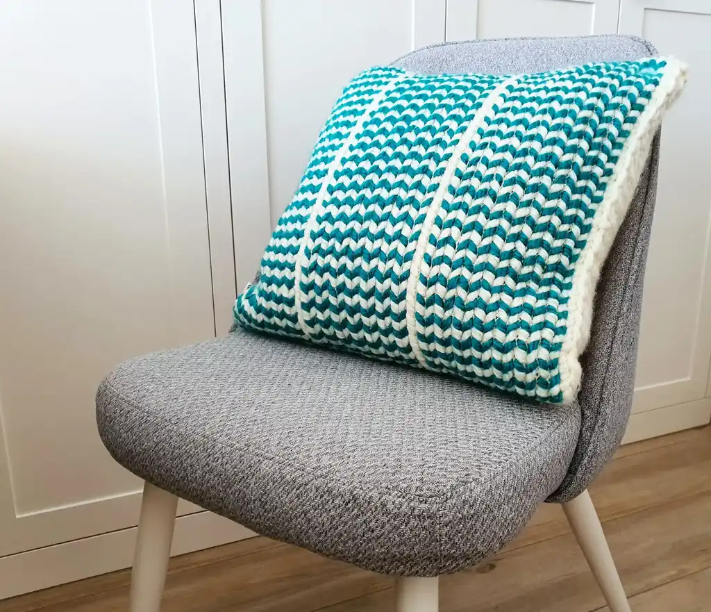Crochet wool cushion in neutral tones.