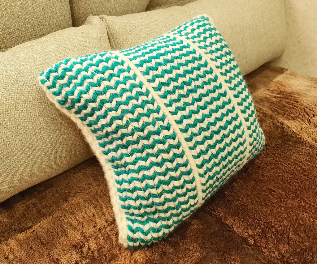 Crochet wool cushion in neutral tones.