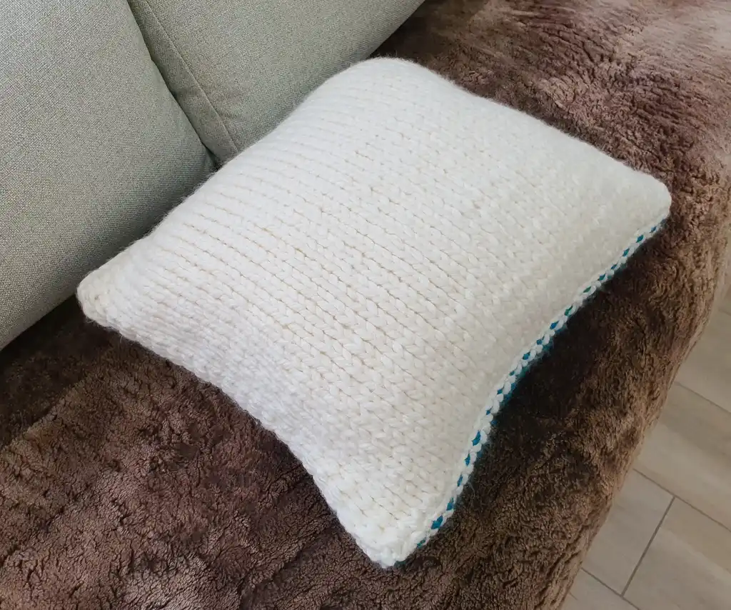 Crochet wool cushion in neutral tones.