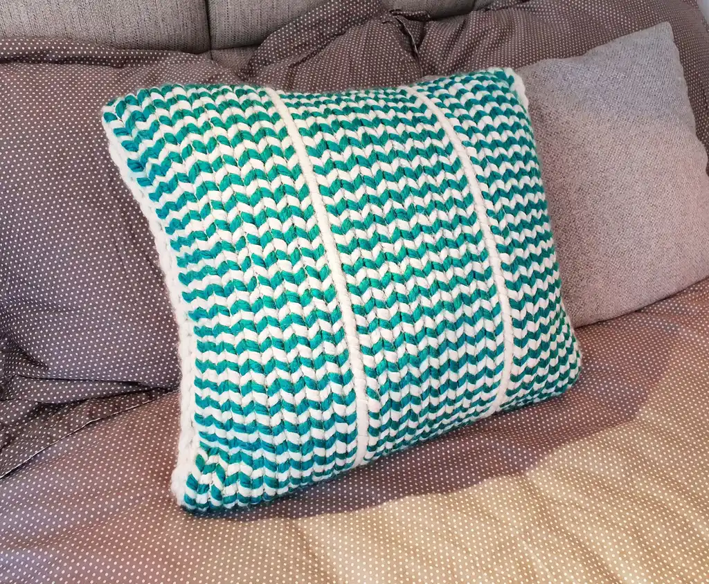 Crochet wool cushion in neutral tones.