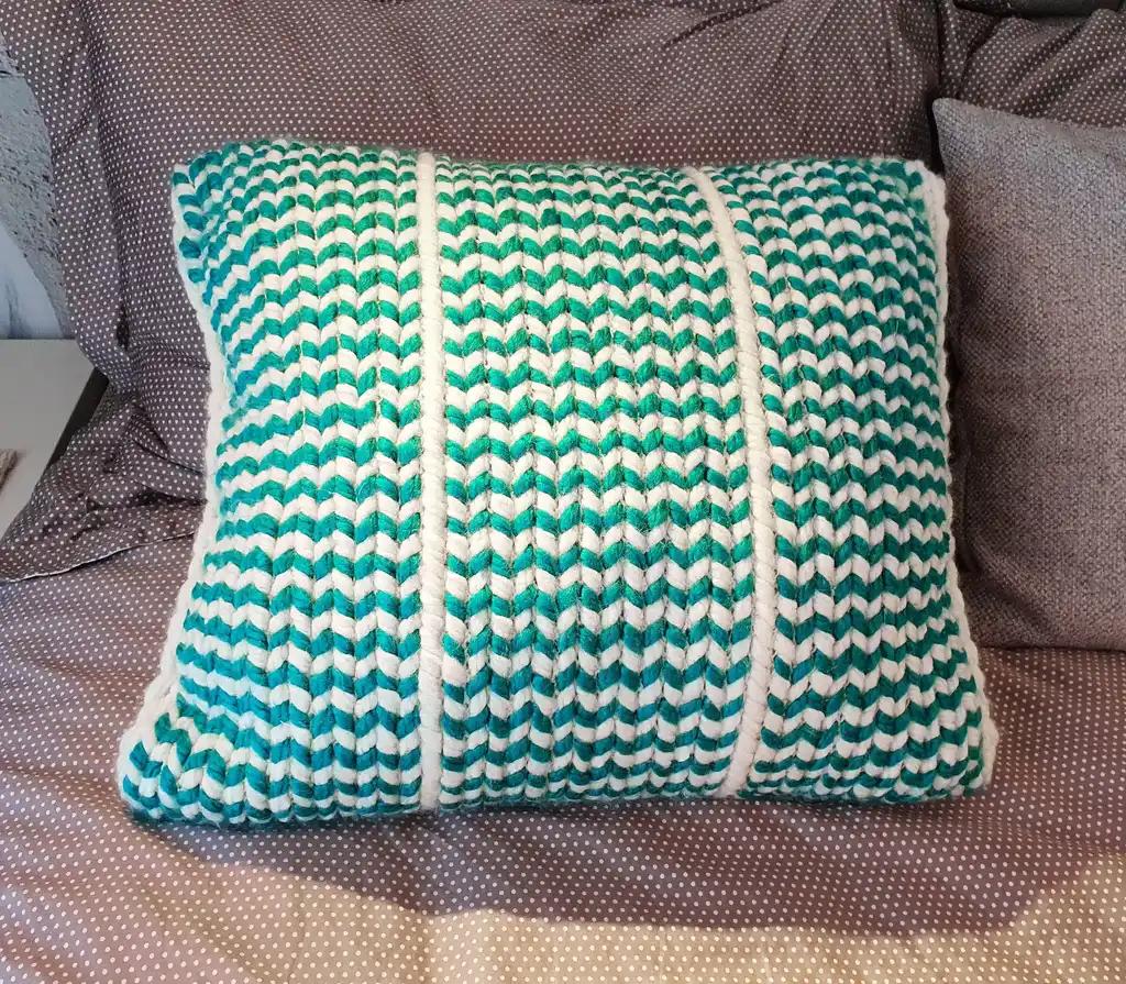 Crochet wool cushion in neutral tones.