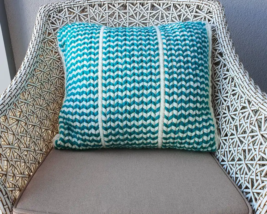 Crochet wool cushion in neutral tones.