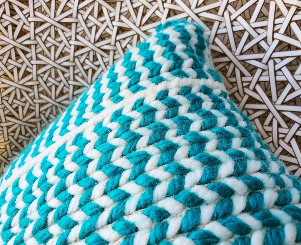 Crochet wool cushion in neutral tones.